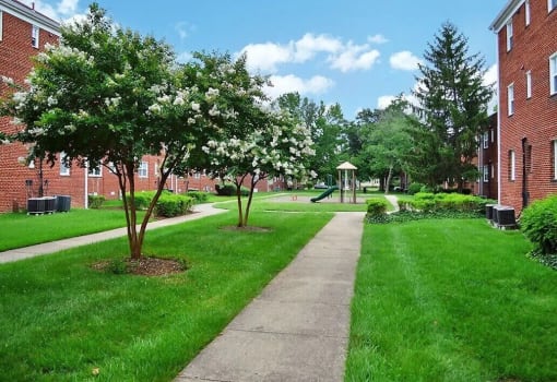 a sidewalk leading to a gazebo in front of a brick building at Parkland Village, Forestville Maryland