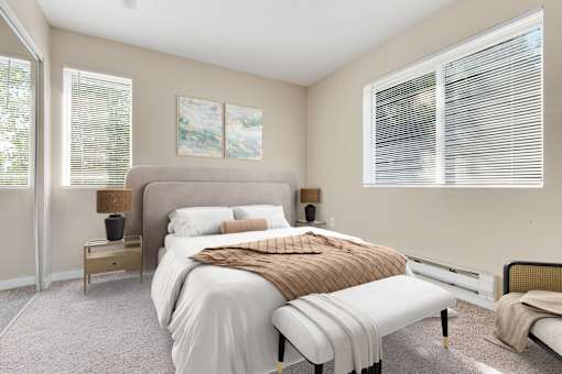 a bedroom with a large bed and two windows at Sage Apartments, Washington