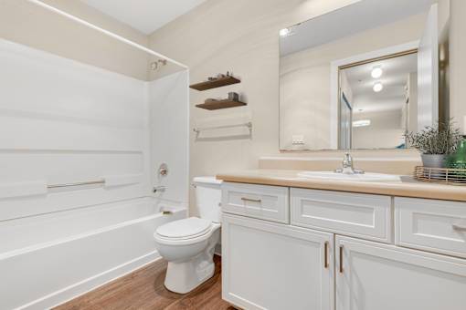 a white bathroom with a toilet and a sink at Sage Apartments, Washington