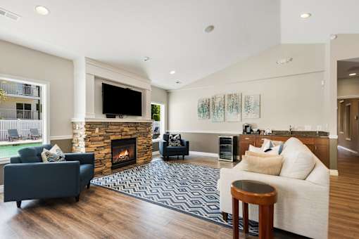 a living room with a fireplace and a couch at Sage Apartments, Everett
