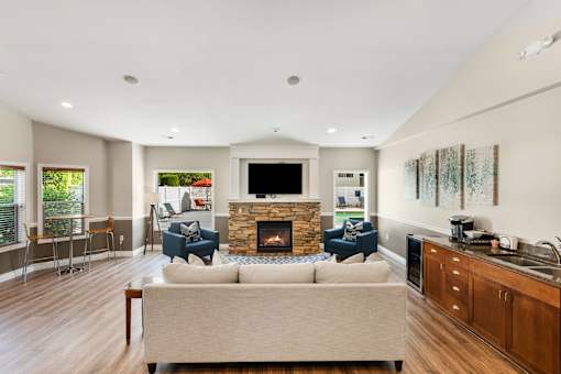a living room with a couch and chairs and a fireplace at Sage Apartments, Washington, 98204