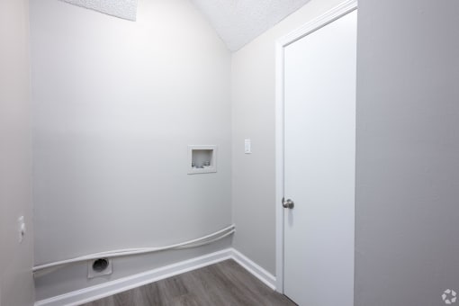 an empty room with white walls and a white door