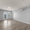 A room with a wooden floor and white walls.