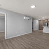 A room with a white wall and a brown floor.
