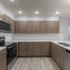 A kitchen with wooden cabinets and a black oven.