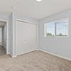 A room with a white door and a window.