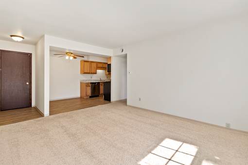 A room with a ceiling fan and a window.