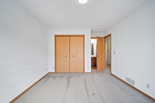 a room with a bathroom and a wooden door