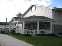 A house with a porch and a covered walkway.