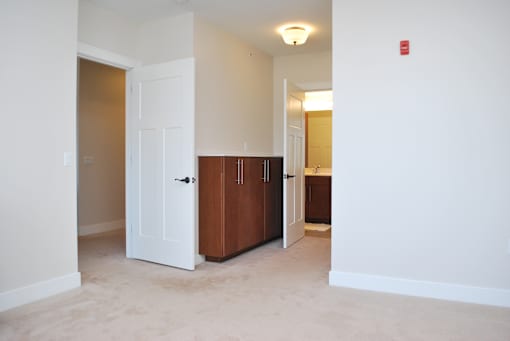 A white door is in a room with a brown cabinet.
