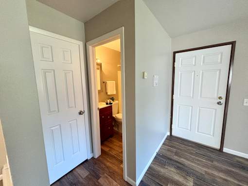 A white door is on the left and a brown door is on the right.