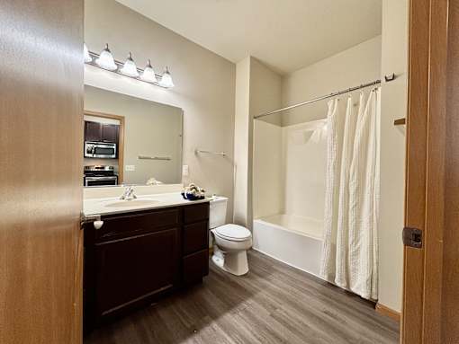 A bathroom with a toilet, sink, and bathtub.