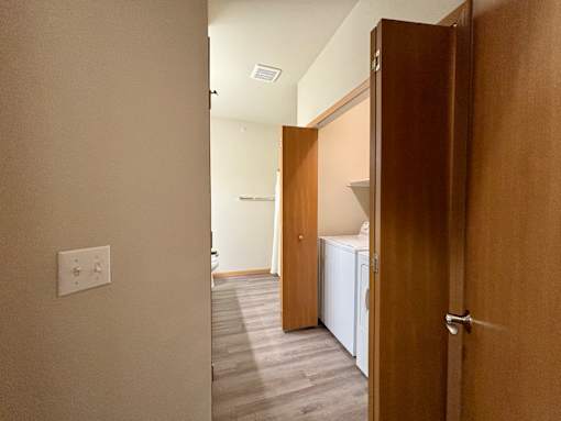 A white washing machine is in a laundry room.