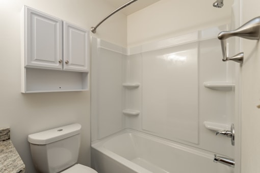 a bathroom with a toilet and a sink and a shower