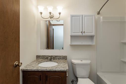 a small bathroom with a sink toilet and mirror