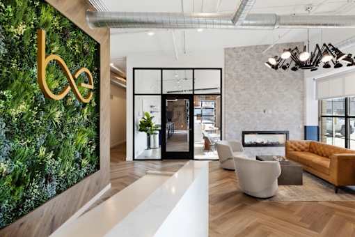 A modern living room with a green wall and a white floor.