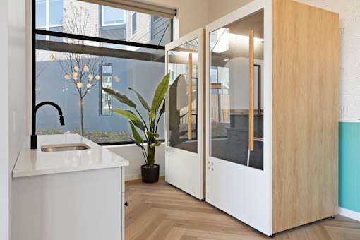 A modern kitchen with a white counter and a sink.