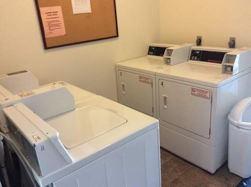 A washing machine and dryer in a laundry room.