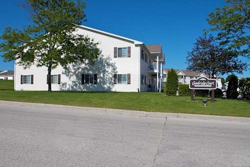 A white building with a sign that says "Chateau Grange" in front of it.