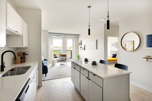 A modern kitchen with white cabinets and a large island.