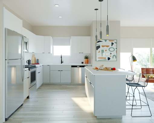 A modern kitchen with white cabinets and a large island.