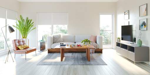 A modern living room with a white sofa, a wooden coffee table, and a TV on a cabinet.