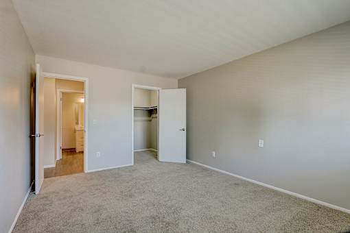 A room with a carpeted floor and white walls.