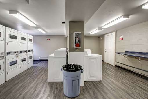 A large room with a trash can in the middle of it.