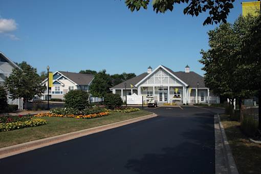 A street view of a residential area with houses and a clear blue sky.