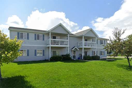 A large two-story house with a balcony on the second floor.