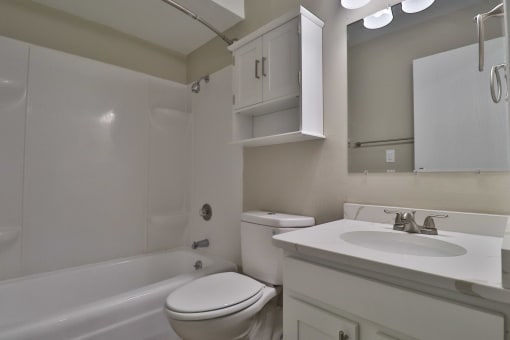 a bathroom with a sink toilet and a bath tub