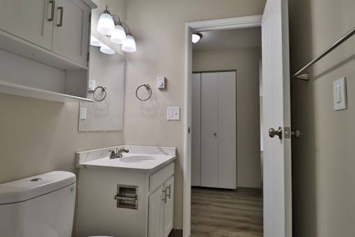 a bathroom with a sink and a mirror and a door