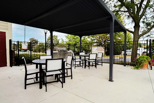 A black metal patio with a table and chairs.