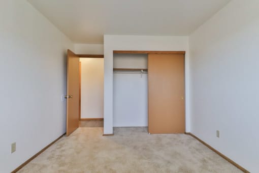 A room with a white door and a brown door.
