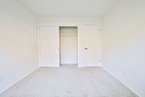 an empty room with white walls and white doors