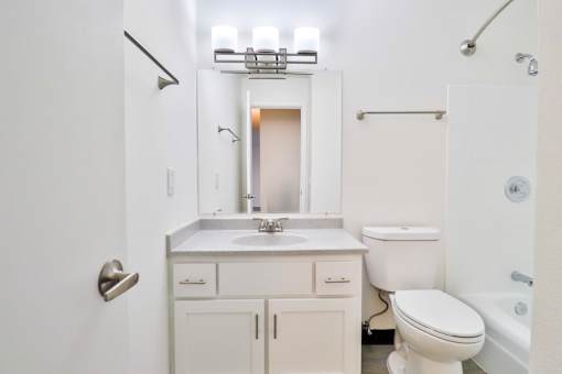 a bathroom with a sink toilet and a mirror