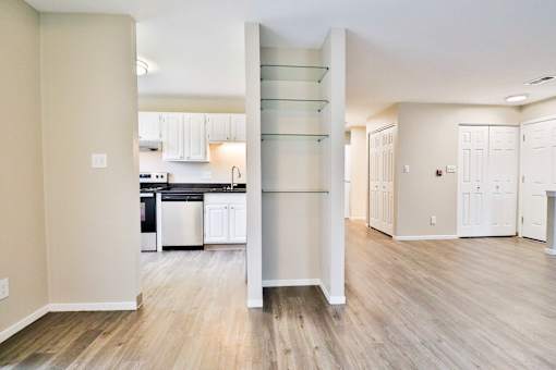 A kitchen with a white cabinetry and a white fridge.