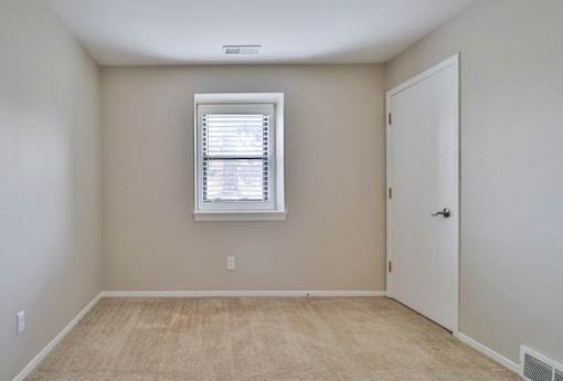 A room with a window and a door.