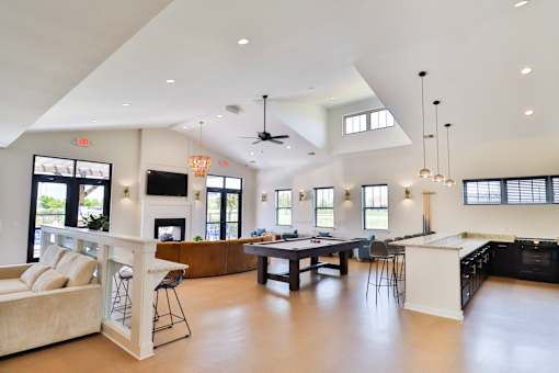 A spacious open-concept living room with a kitchen and dining area.