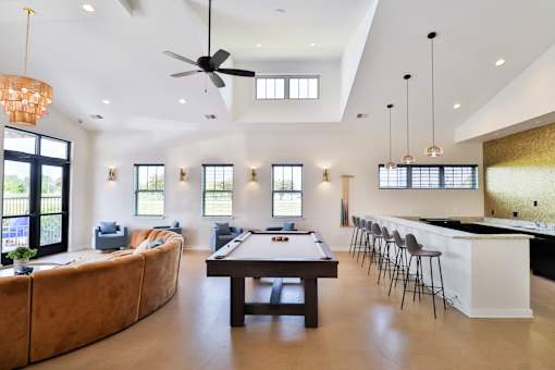 A large room with a pool table and bar.