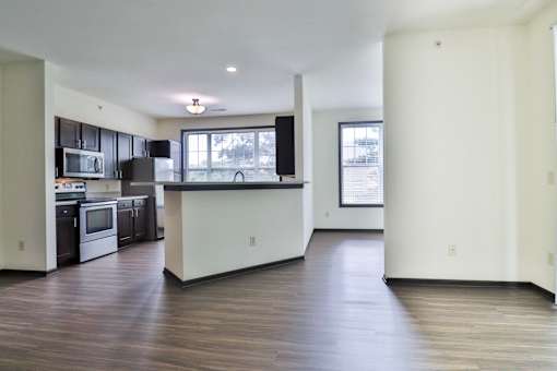 A kitchen with black cabinets and a white island.