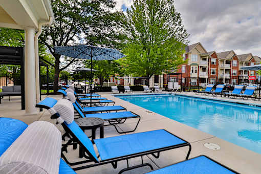 A poolside area with sun loungers and a pool.