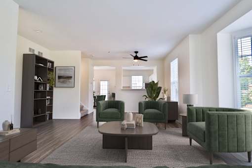 A living room with a green chair and a grey rug.
