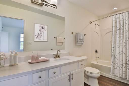 A white bathroom with a sink, toilet, and bathtub.