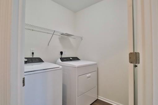 A white laundry room with a washer and dryer.