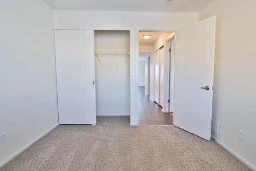 A white door is open to a hallway.