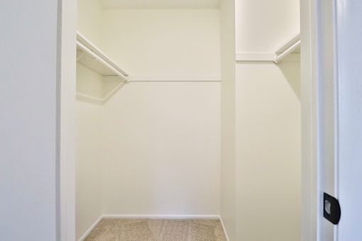 A white hallway with a door on the right.