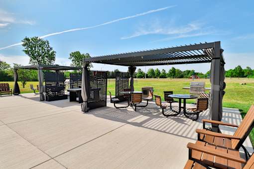 A patio with a table and chairs under a canopy.