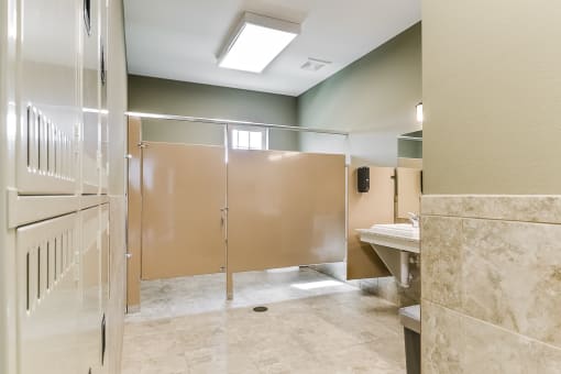 a public bathroom with frosted glass doors