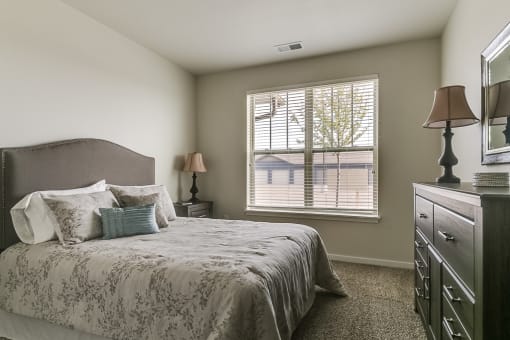 a bedroom with a large bed and a dresser